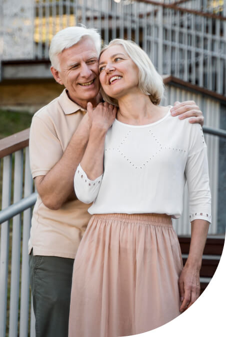 front-view-loving-senior-couple-posing-outdoors