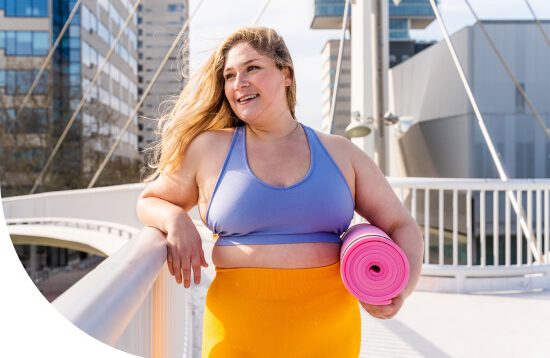 young-woman-standing-with-yoga-mat-1